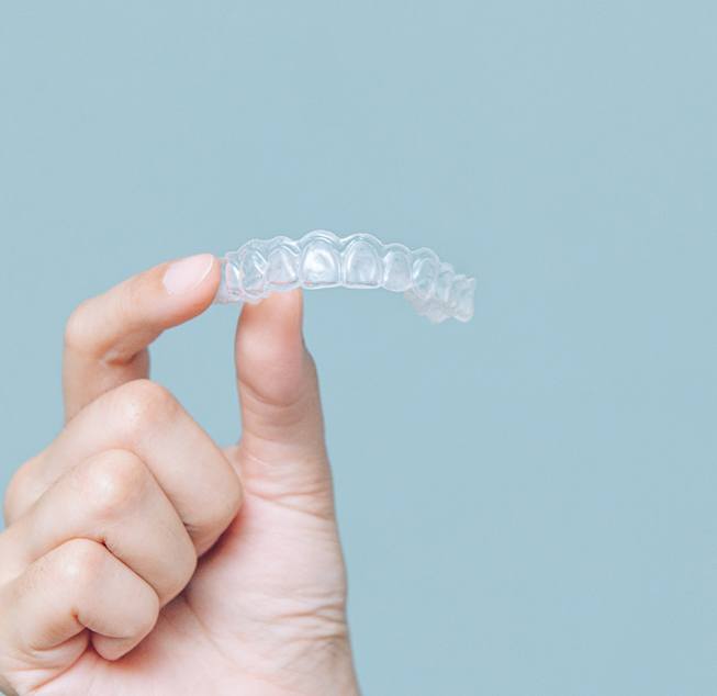 Patient holding clear aligner